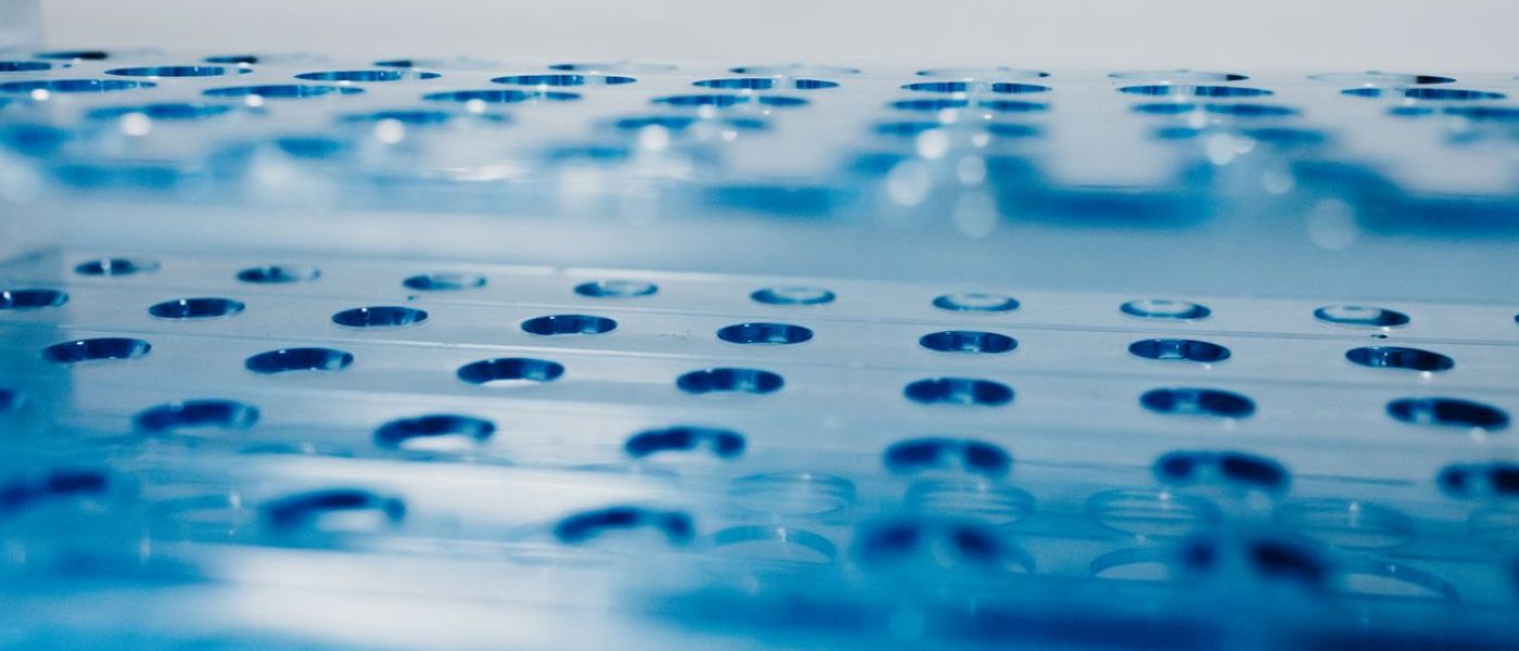 Detailed view of a blue laboratory test tube rack illustrating science and research themes.
